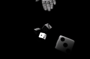 hand-throwing-a-pair-of-dice-in-black-and-white-anya-brewley-schultheiss